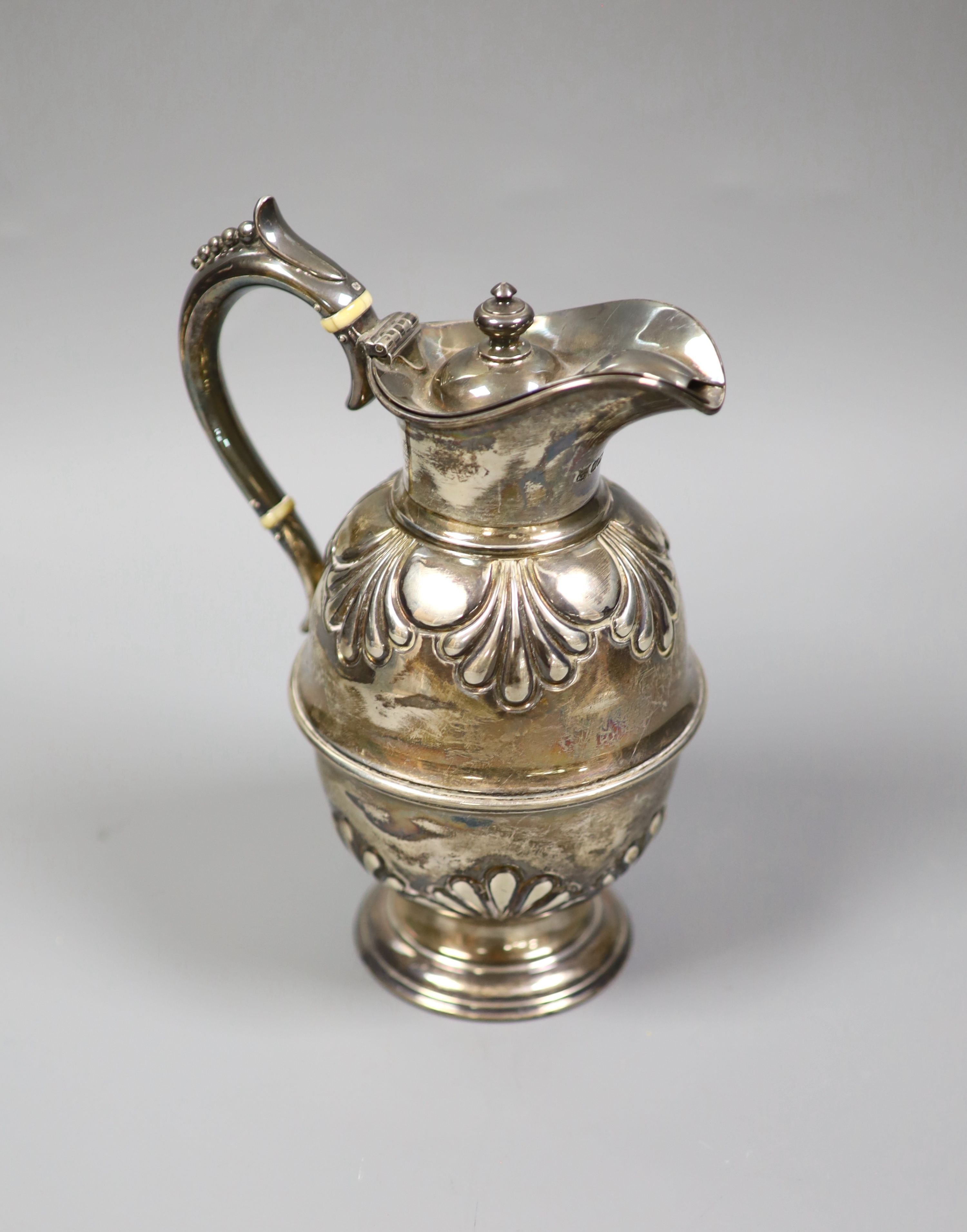 A late Victorian embossed silver hot water jug, Sheffield, 1900, 19cm, gross 10.5oz.